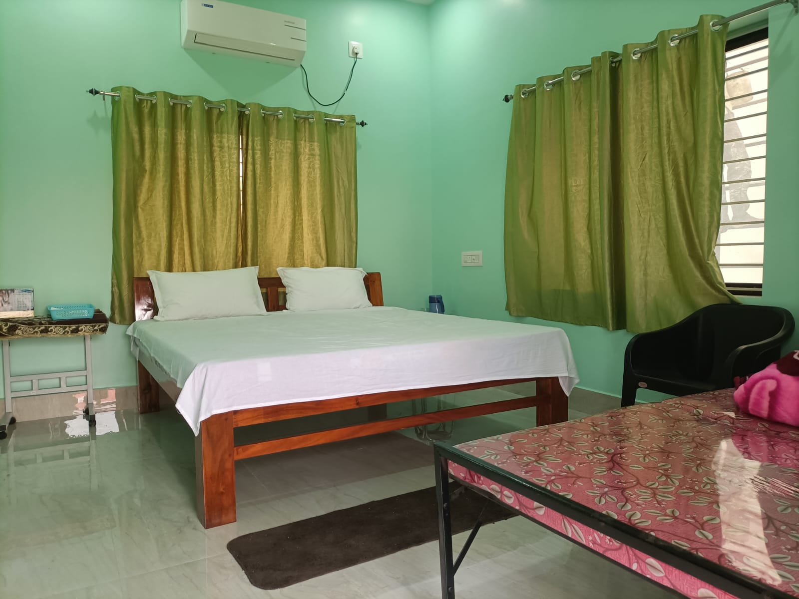 Bedroom with bright windows and colorful cushions